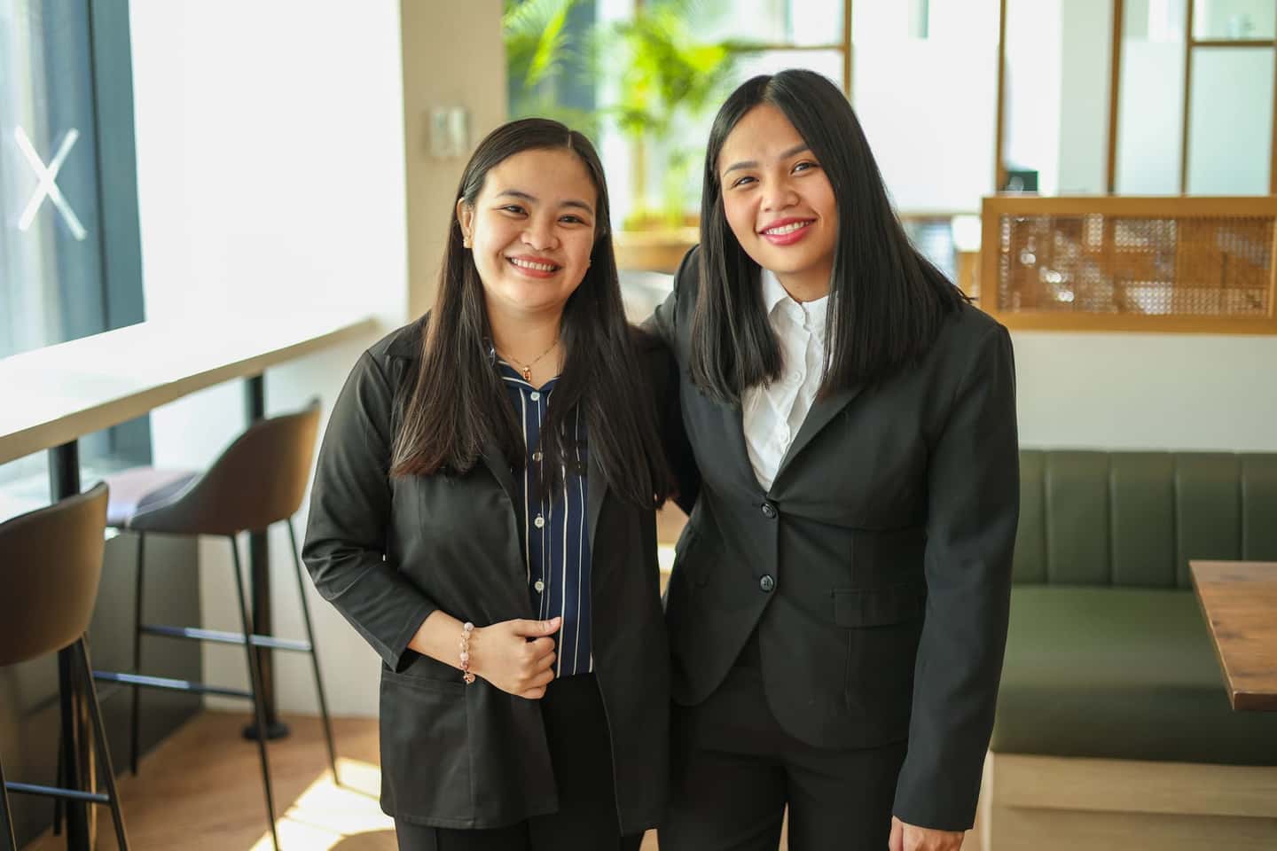 Two HavenStone advisors standing together and smiling in the office lounge